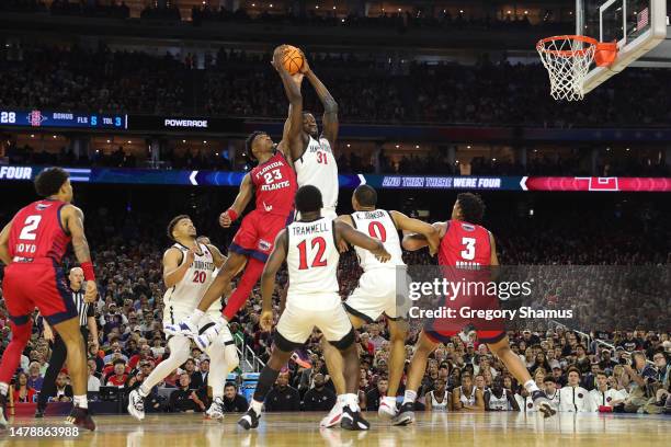 Nathan Mensah of the San Diego State Aztecs and Brandon Weatherspoon of the Florida Atlantic Owls battle for the ball during the first half during...