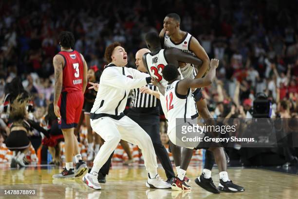 Lamont Butler of the San Diego State Aztecs celebrates with teammates after making a game winning basket to defeat the Florida Atlantic Owls 72-71...