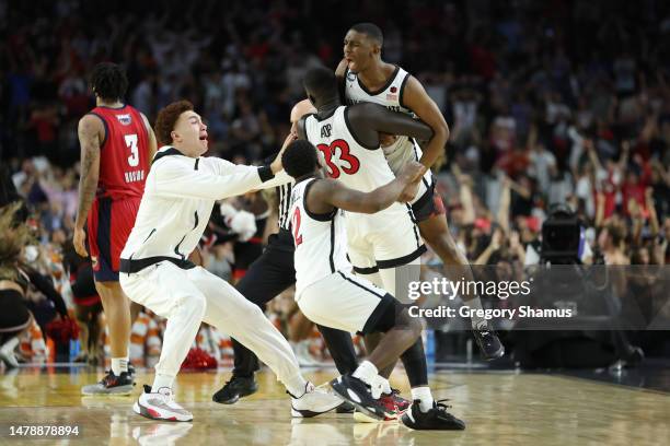 Lamont Butler of the San Diego State Aztecs celebrates with teammates after making a game winning basket to defeat the Florida Atlantic Owls 72-71...