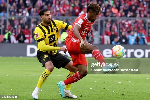 Kingsley Coman of FC Bayern Munich battles for possession with Emre Can of Borussia Dortmund during the Bundesliga match between FC Bayern München...