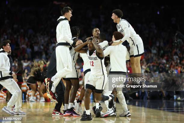 Darrion Trammell of the San Diego State Aztecs and teammates celebrate after defeating the Florida Atlantic Owls 72-71 during the NCAA Men's...