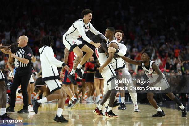 Lamont Butler of the San Diego State Aztecs celebrates with teammates after making a game winning basket to defeat the Florida Atlantic Owls 72-71...