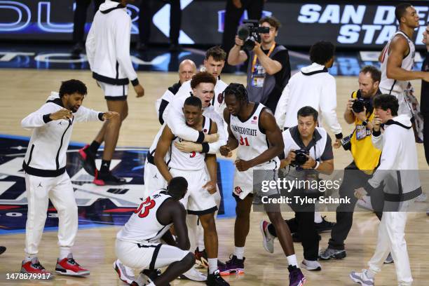 Lamont Butler of the San Diego State Aztecs celebrates with teammates after winning the game against the Florida Atlantic Owls during the NCAA Men’s...