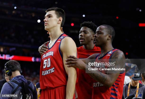 Vladislav Goldin and Johnell Davis of the Florida Atlantic Owls react as they walk off the floor after losing to the San Diego State Aztecs 72-71...
