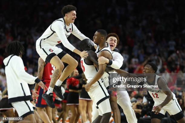 Lamont Butler of the San Diego State Aztecs celebrates with teammates after making a game winning basket to defeat the Florida Atlantic Owls 72-71...