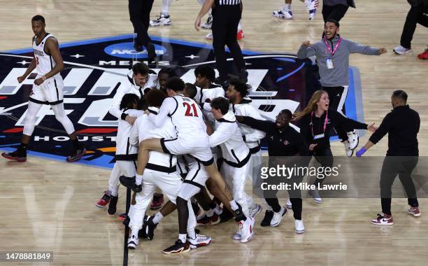 Lamont Butler of the San Diego State Aztecs celebrates with teammates after making a game winning basket to defeat the Florida Atlantic Owls 72-71...