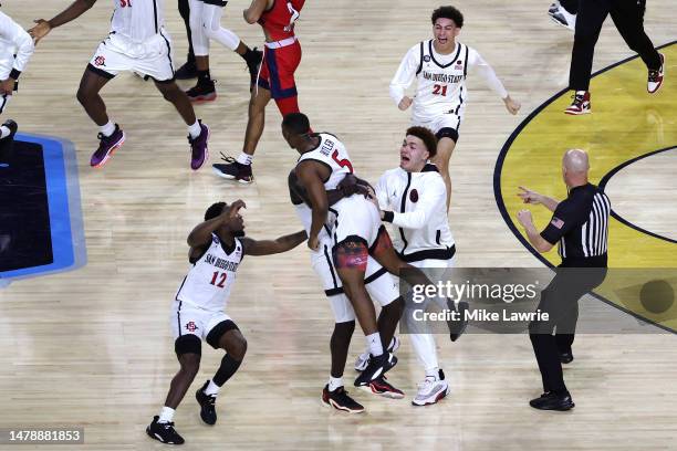 Lamont Butler of the San Diego State Aztecs celebrates with teammates after making a game winning basket to defeat the Florida Atlantic Owls 72-71...