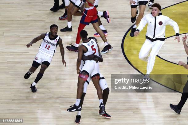 Lamont Butler of the San Diego State Aztecs celebrates with teammates after making a game winning basket to defeat the Florida Atlantic Owls 72-71...