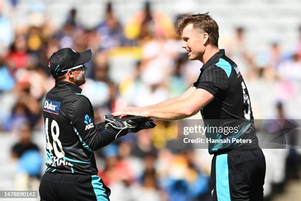 Jimmy Neesham of the Black Caps celebrates the wicket of Dhananjaya de Silva of Sri Lanka with Tom Latham of the Black Caps during game one in the...