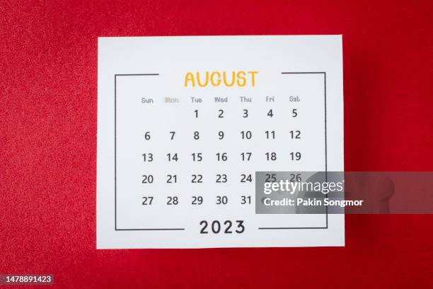 calendar desk 2023: august is the month for the organizer to plan and deadline with a red paper background. - august stock-fotos und bilder