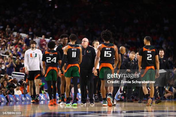 Miami Hurricanes players huddle on the court with head coach Jim Larrañaga in the first half of the NCAA Men’s Basketball Tournament Final Four...