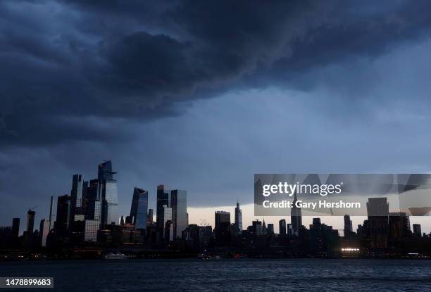 Thunderstorm passes over midtown Manhattan and the Empire State Building in New York City on April 1 as seen from Hoboken, New Jersey.