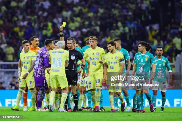 Fernando Hernandez referee shows the yellow card to Diego Valdés of America during the 13th round match between America and Leon as part of the...