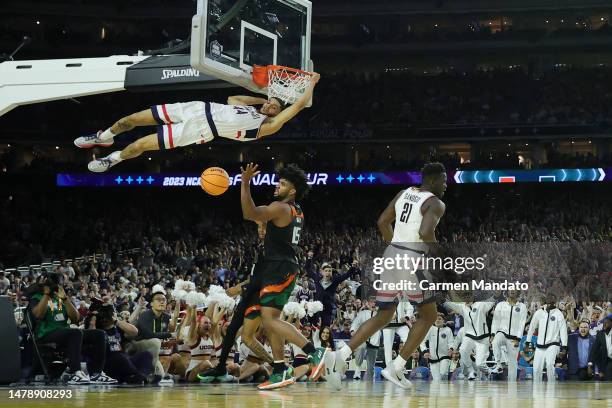 Andre Jackson Jr. #44 of the Connecticut Huskies hangs on to the rim after dunking the ball during the second half against the Miami Hurricanes...