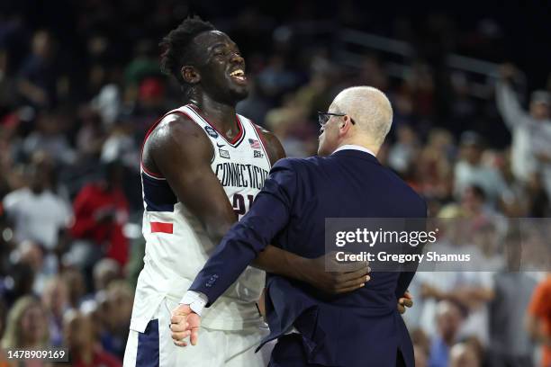 Adama Sanogo of the Connecticut Huskies celebrates with Head coach Dan Hurley after defeating the Miami Hurricanes 72-59 during the NCAA Men's...