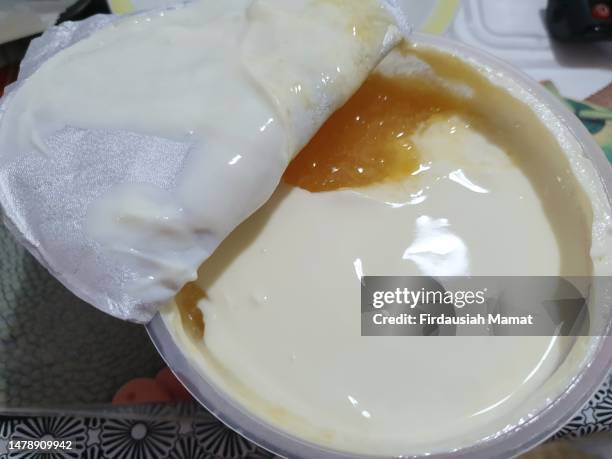 close up of pineapple yogurt in plastic tub - yoghurt tub stock pictures, royalty-free photos & images