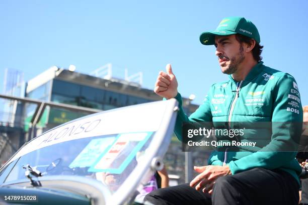 Fernando Alonso of Spain and Aston Martin F1 Team waves to the crowd on the drivers parade prior to the F1 Grand Prix of Australia at Albert Park...