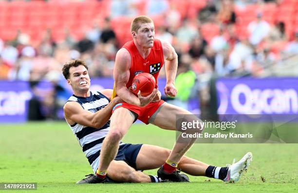 Matt Rowell of the Suns attempts to break free from the defence during the round three AFL match between Gold Coast Suns and Geelong Cats at Heritage...