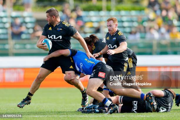 Dane Coles of the Hurricanes is tackled by during the round six Super Rugby Pacific match between Hurricanes and Western Force at Central Energy...