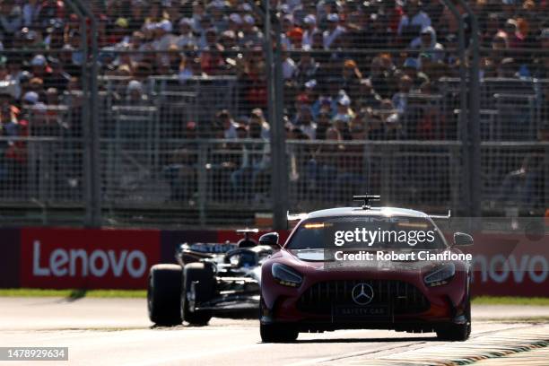 The FIA Safety Car leads George Russell of Great Britain driving the Mercedes AMG Petronas F1 Team W14 and the rest of the field during the F1 Grand...