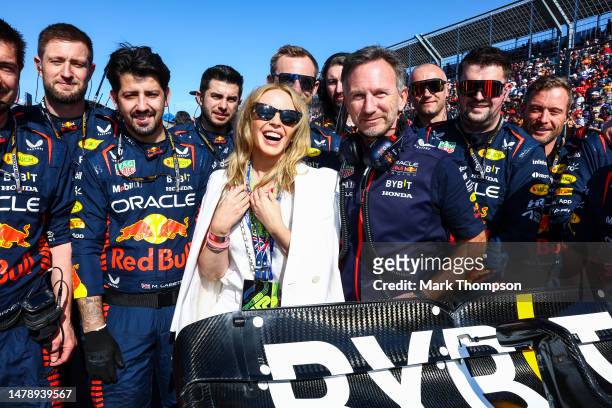 Kylie Minogue poses for a photo with Red Bull Racing Team Principal Christian Horner and the Red Bull Racing team on the grid during the F1 Grand...
