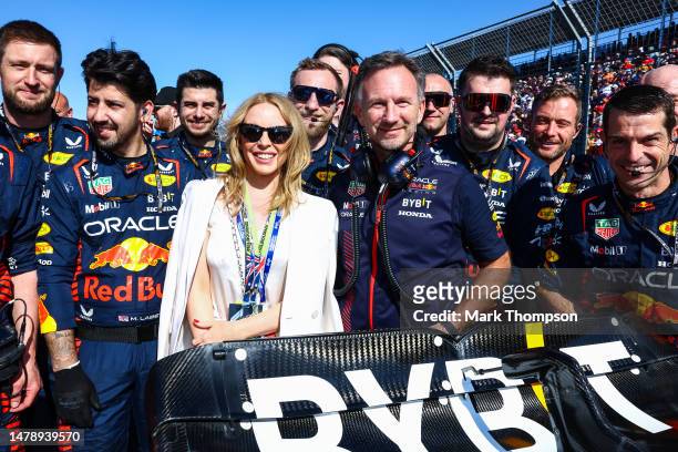 Kylie Minogue poses for a photo with Red Bull Racing Team Principal Christian Horner and the Red Bull Racing team on the grid during the F1 Grand...