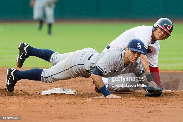 Second baseman Sean Rodriguez of the Tampa Bay Rays and Shin-Soo Choo of the Cleveland Indians watch to see the throw to first during the fourth...