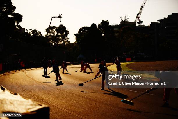 Track marshals clear debris from the circuit during a red flag delay during the F1 Grand Prix of Australia at Albert Park Grand Prix Circuit on April...