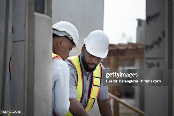 a manger is discussing with construction worker at construction site. - manger stock pictures, royalty-free photos & images