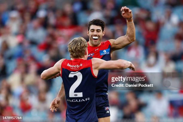 Jacob van Rooyen of the Demons celebrates with Christian Petracca of the Demons after kicking a goal during the round three AFL match between...