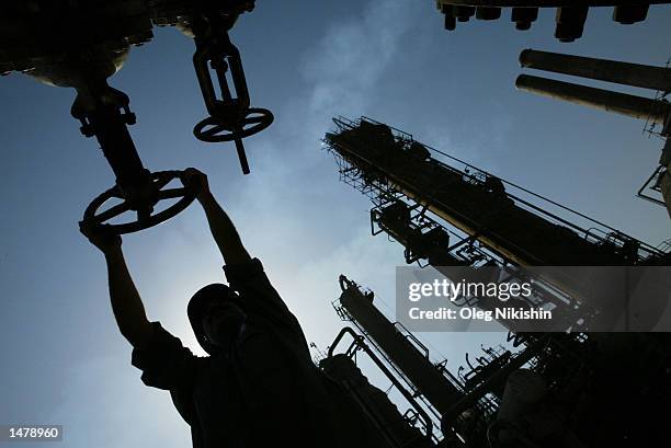 An Iraqi oil worker works at Al-Doura oil refinery October 14, 2002 in Baghdad, Iraq. U.S. President George W. Bush signed a congressional resolution...