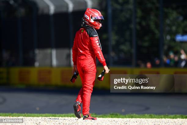 Charles Leclerc of Monaco and Ferrari walks from his car after retiring from the race during the F1 Grand Prix of Australia at Albert Park Grand Prix...