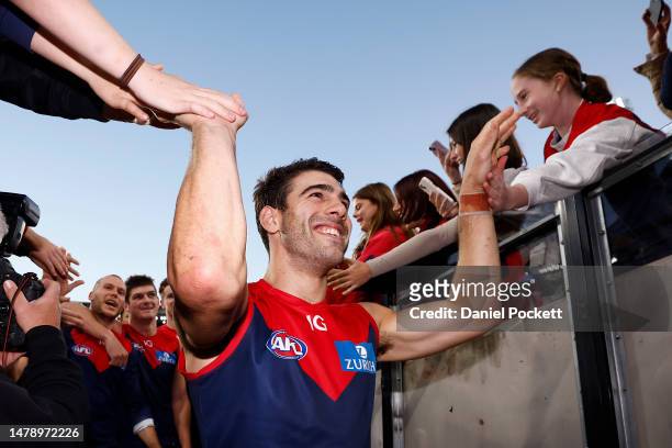Christian Petracca of the Demons celebrates with fans after winning the round three AFL match between Melbourne Demons and Sydney Swans at Melbourne...