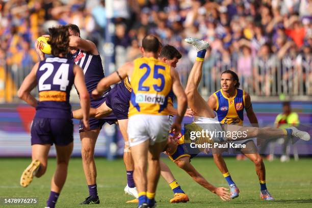 Sean Darcy of the Dockers marks the ball as Alex Witherden of the Eagles collides with Jaeger O'Meara during the round three AFL match between...