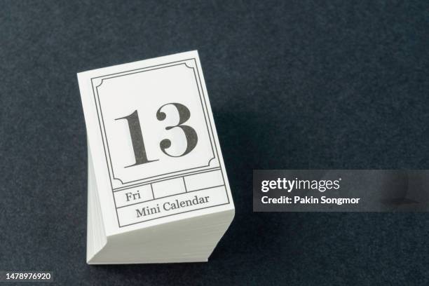 mini calendar with the date friday the 13th on a black background. - friday the 13th stock pictures, royalty-free photos & images