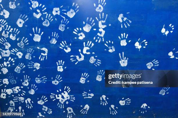 white handprints on a blue wall - hand prints in cement stock pictures, royalty-free photos & images