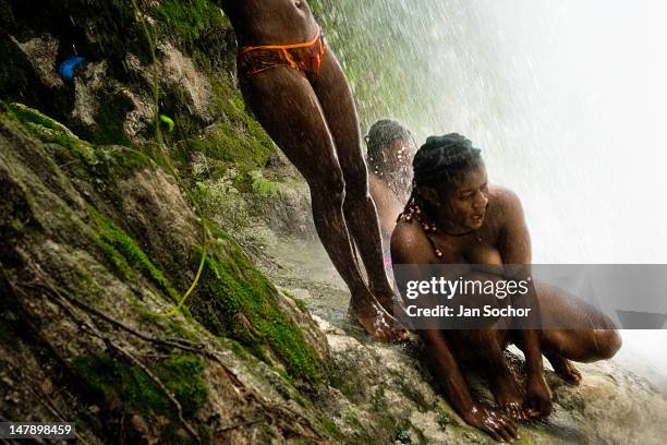 Haitian women make bathing and cleaning ritual under the 100 foots high waterfall of Saut d'Eau on July 16, 2008 in Ville Bonheur, Haiti. Every year...