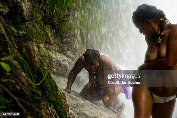 Haitian women make bathing and cleaning ritual under the 100 foot high waterfall of Saut d'Eau on July 16, 2008 in Ville Bonheur, Haiti. Every year...