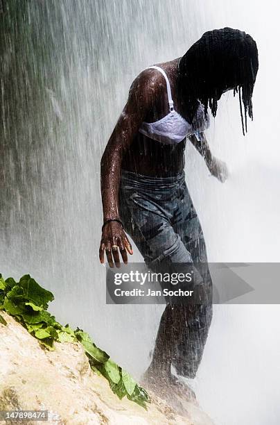 Young Haitian girl performs the cleaning and spiritual ritual right under the Saut d'Eau waterfall on July 16, 2008 in Ville Bonheur, Haiti. Every...