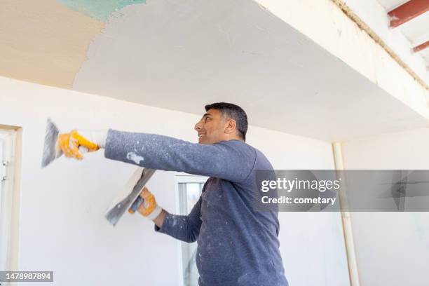 worker plastering with tool plaster - gypsum stock pictures, royalty-free photos & images