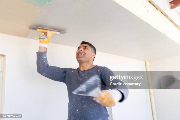 worker plastering with tool plaster - gypsum stock pictures, royalty-free photos & images