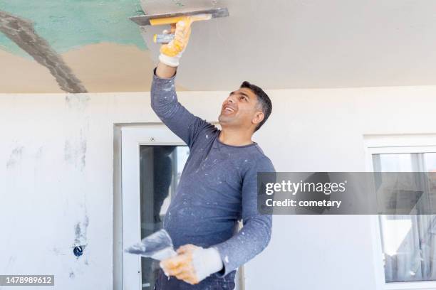 worker plastering with tool plaster - gypsum stock pictures, royalty-free photos & images