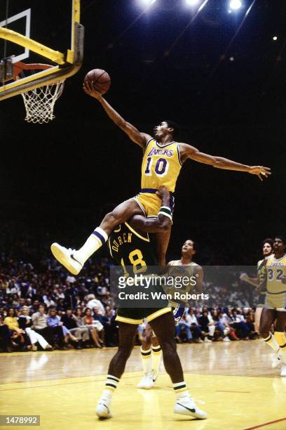 Norm Nixon of the Los Angeles Lakers drives over the top of John Duren of the Indiana Pacers in Los Angeles, California. NOTE TO USER: User expressly...