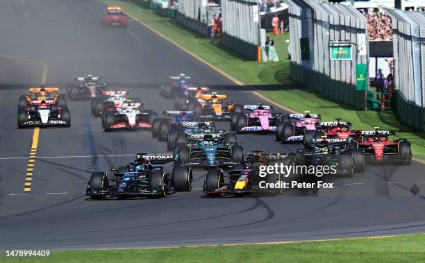 George Russell of Great Britain driving the Mercedes AMG Petronas F1 Team W14 and Max Verstappen of the Netherlands driving the Oracle Red Bull...