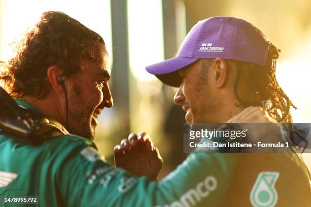 Second placed Lewis Hamilton of Great Britain and Mercedes and Third placed Fernando Alonso of Spain and Aston Martin F1 Team celebrate in parc ferme...