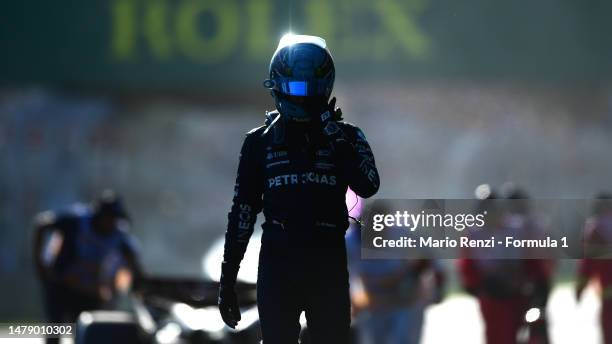 George Russell of Great Britain and Mercedes walks from his car after retiring from the race during the F1 Grand Prix of Australia at Albert Park...