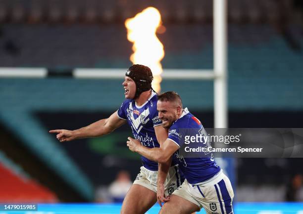 Matt Burton of the Bulldogs celebrates kicking the winning field goal with Josh Reynolds of the Bulldogs in extra time during the round five NRL...