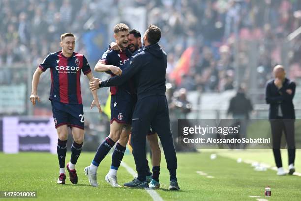 Stefan Posch of Bologna FC celebrates with teammates and Thiago Motta, Head Coach of Bologna FC, after scoring the team's first goal during the Serie...