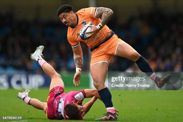 Ben Lam of Montpellier is tackled by Henry Slade of Exeter Chiefs during the Heineken Champions Cup Round Of Sixteen match between Exeter Chiefs and...