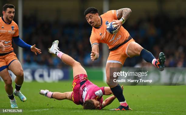 Ben Lam of Montpellier is tackled by Henry Slade of Exeter Chiefs during the Heineken Champions Cup Round Of Sixteen match between Exeter Chiefs and...